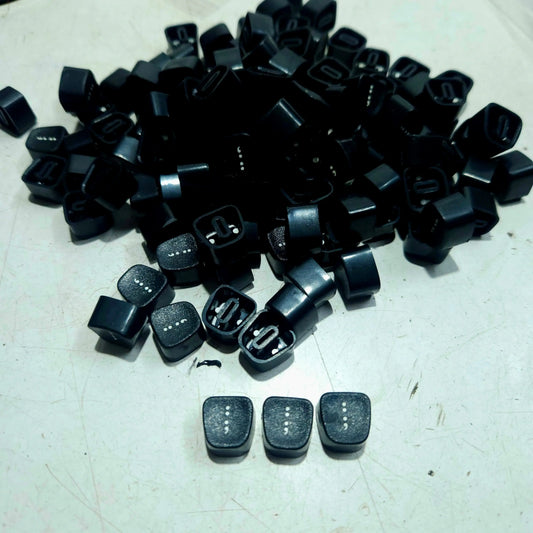 Black Godrej colon keytops displayed on a table, manual typewriter parts from RR Typewriter Mart for repair work