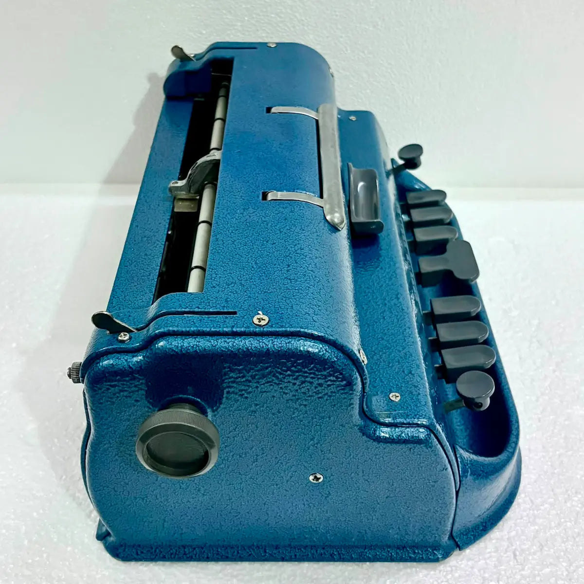 Elevated view of a blue Perkins Brailler typewriter showing carriage and keys, ideal to Buy Braille Typewriter from RR Typewriter Mart