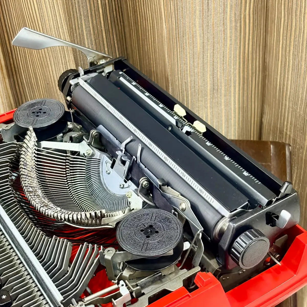 Brother Young Elite 513 vintage typewriter, close-up of black keyboard and red housing on a Japanese portable typing machine | RR Typewriter Mart
