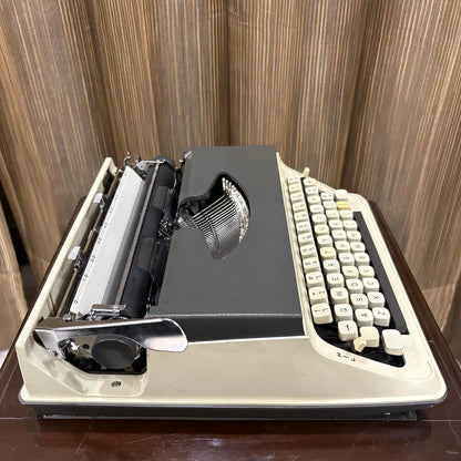 Japanese Kovac portable typewriter with a refined ivory white body, grey top panel and classic vintage character | RR Typewriter Mart
