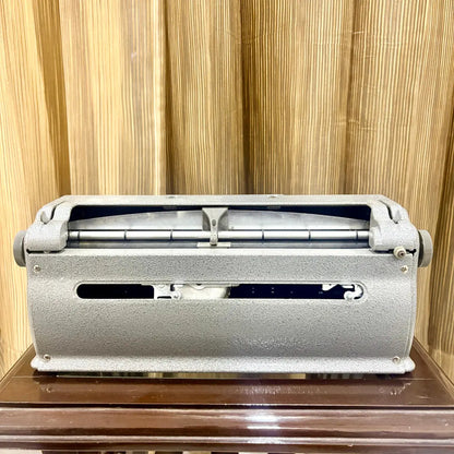 Low front view of the Perkins Brailler showing its six key layout and textured grey factory paint at RR Typewriter Mart for Braille users.