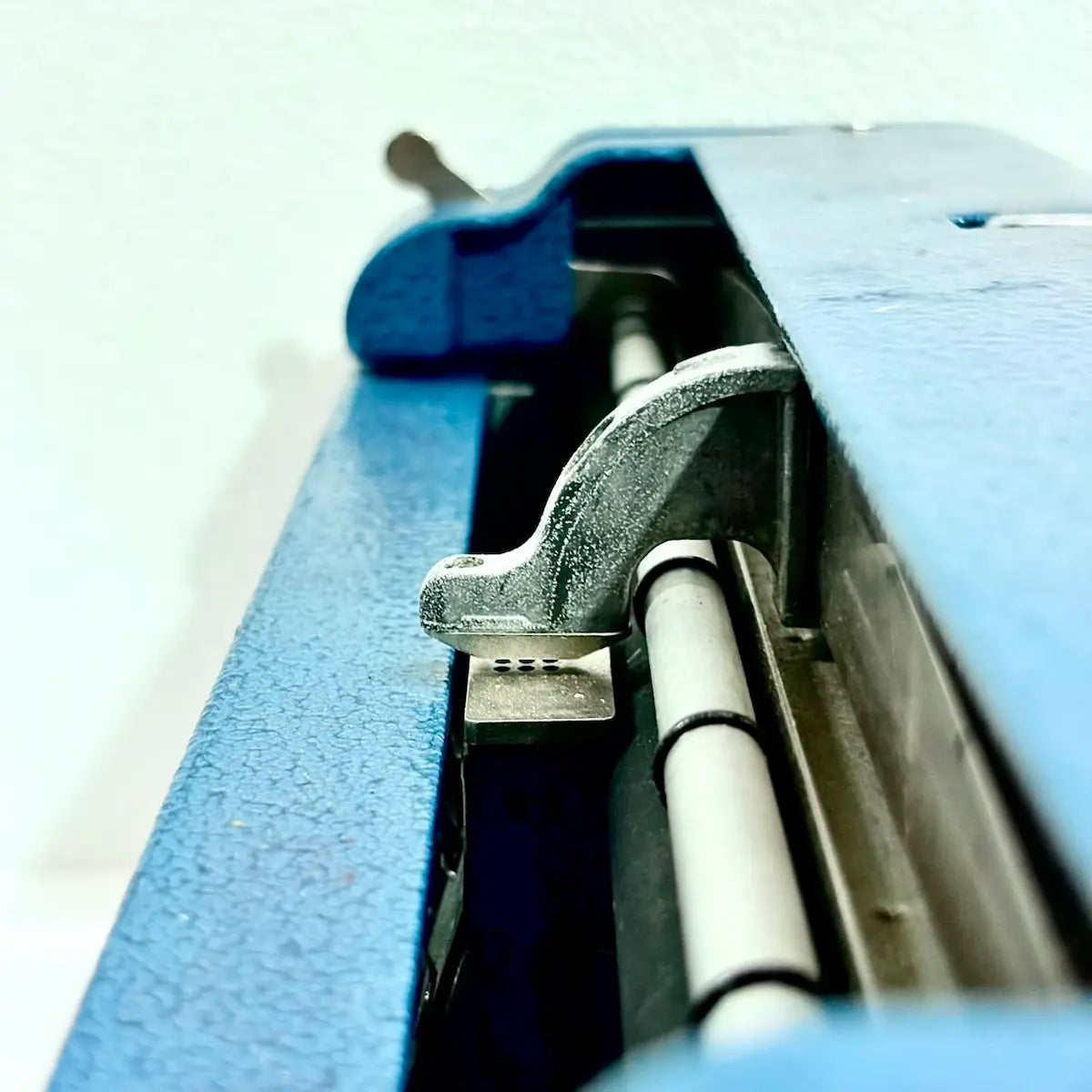 Close-up of Perkins Brailler roller and metal mechanism, showing the braille typing machine detail from RR Typewriter Mart.
