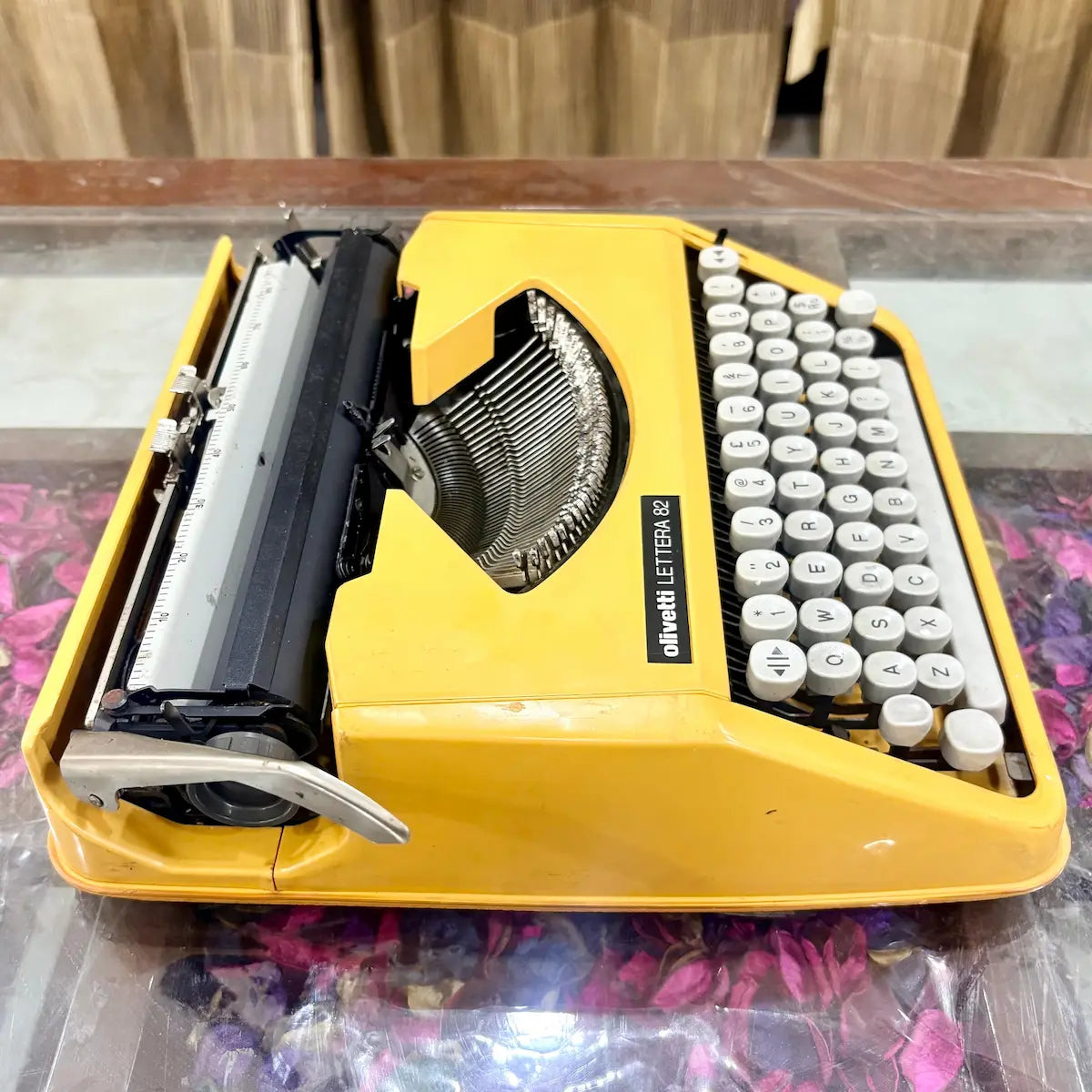 Close-up of yellow Olivetti Lettera 82 keyboard and typebars, vintage manual typewriter at RR Typewriter Mart