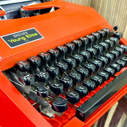 Brother Young Elite 513 scarlet red vintage typewriter, detailed view of keyboard layout and manual typing controls | RR Typewriter Mart