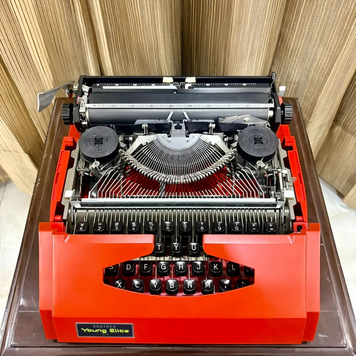 Close-up of Brother Young Elite 513 typewriter carriage and platen, showing mechanical parts of this vintage portable machine | RR Typewriter Mart