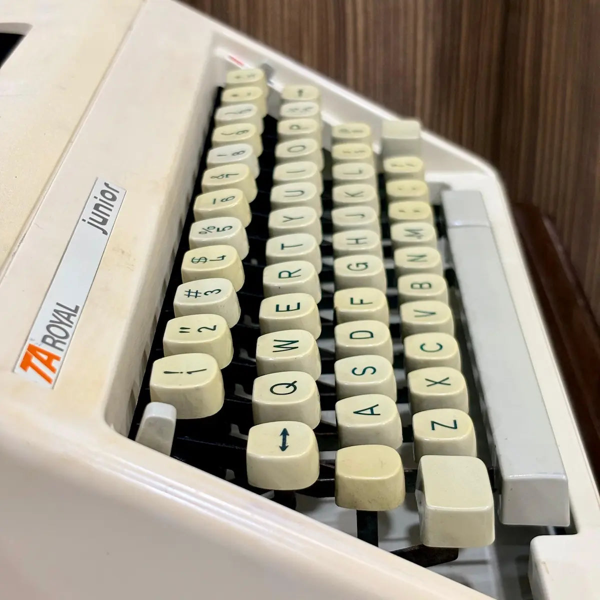 Royal Junior typing machine close-up showing cream QWERTY keys and Royal Junior body, from RR Typewriter Mart.