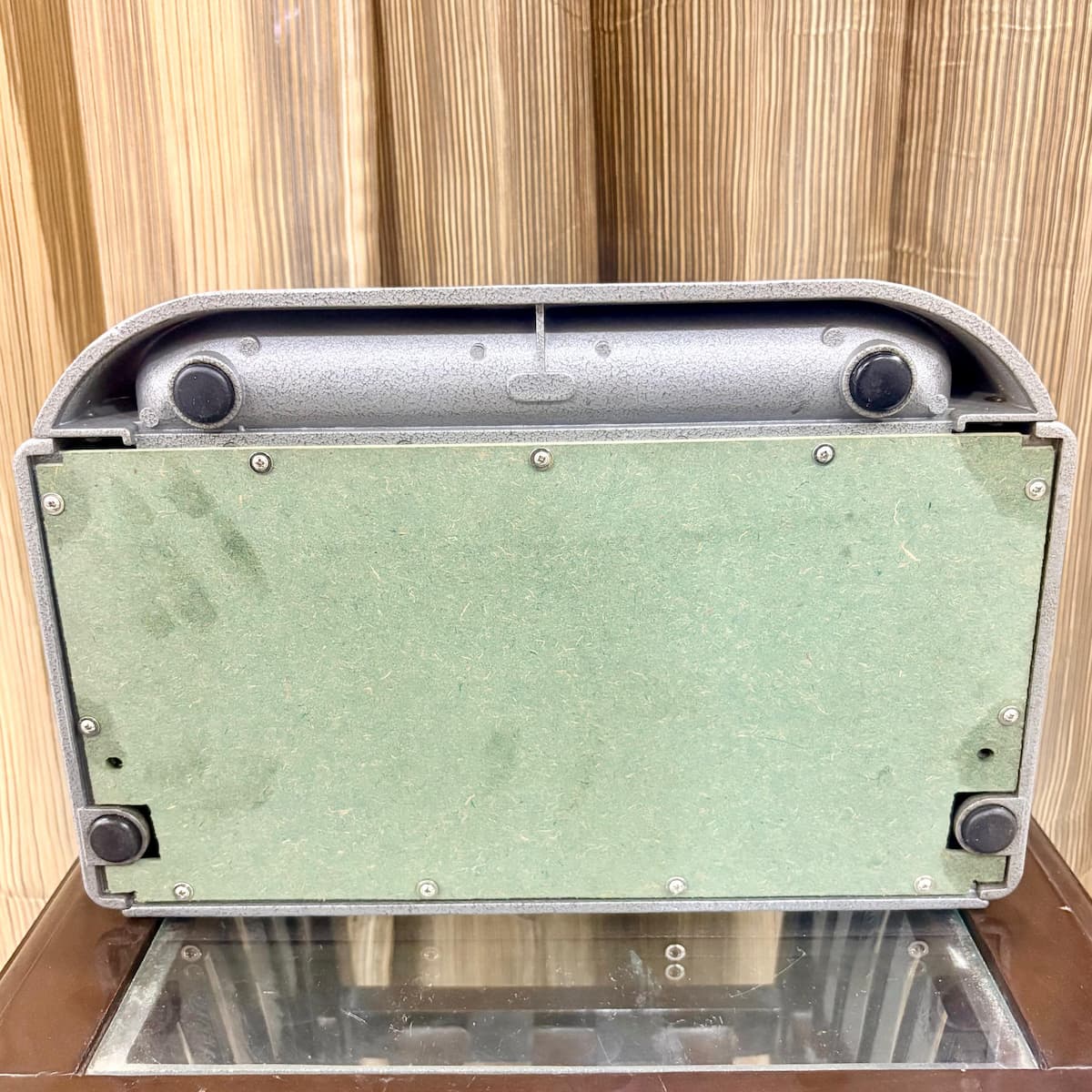 Three quarter side view of the mint grey American Perkins Brailler showing its preserved body and case at RR Typewriter Mart in India.