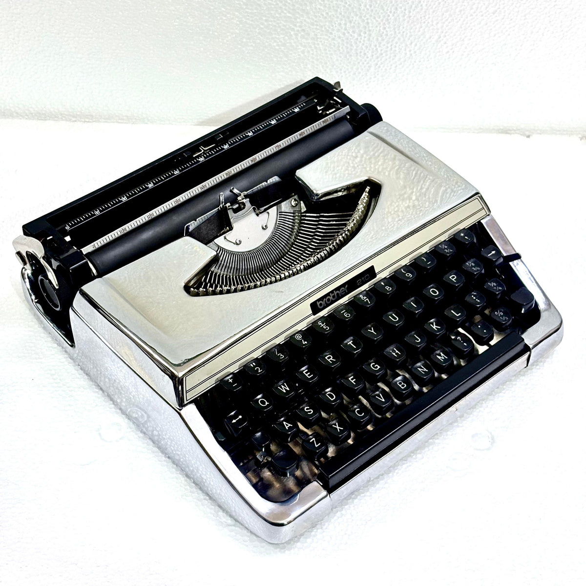 Mirror chrome Brother 210 typewriter with vintage portable design and tested typing action from RR Typewriter Mart