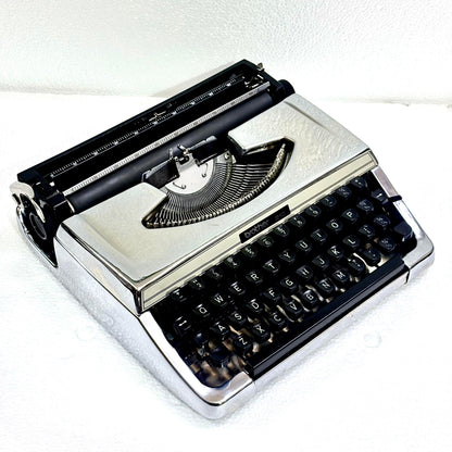 Mirror chrome Brother 210 typewriter with vintage portable design and tested typing action from RR Typewriter Mart