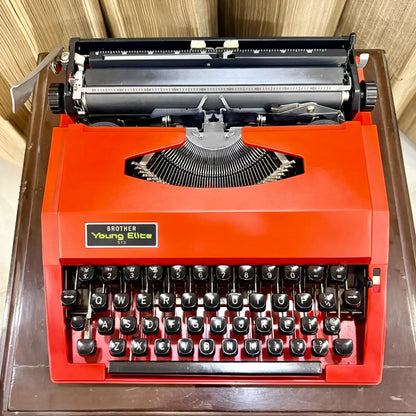 Brother Young Elite 513 scarlet red manual typewriter front view, English QWERTY keyboard and vintage Japanese portable design | RR Typewriter Mart