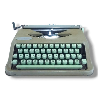 Hermes Baby Rocket portable typewriter low front view showing mint green English keyboard and compact Swiss body