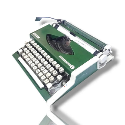 Angled view of Olympia Traveller De Luxe green portable typewriter, German typing machine with original finish