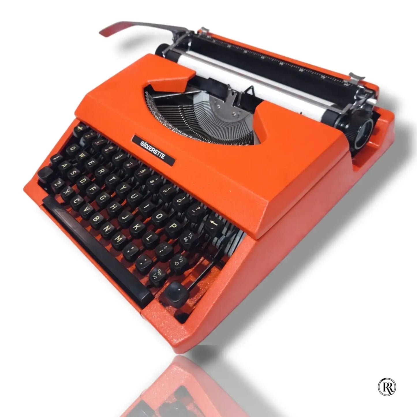 Angled view of Silver Reed Silverette II portable typewriter in Cosmic Orange by RR Typewriter Mart