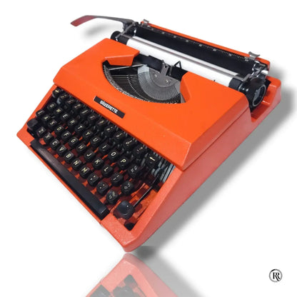 Angled view of Silver Reed Silverette II portable typewriter in Cosmic Orange by RR Typewriter Mart