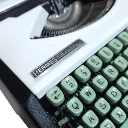 Hermes Baby typewriter logo close up Swiss portable manual typing machine – RR Typewriter Mart