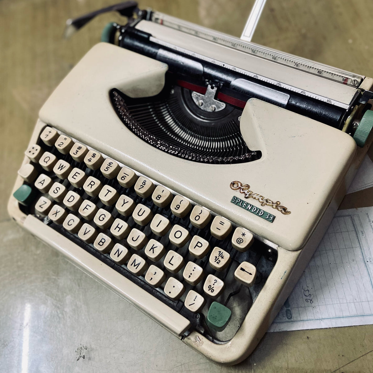 Vintage Olympia Splendid 33 typewriter in cream, portable manual typing machine with classic QWERTY keys