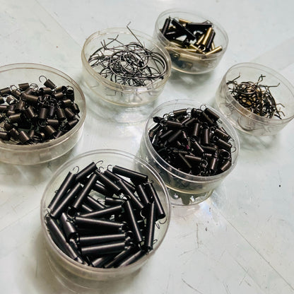 Mixed springs for typewriter repair and servicing displayed in containers, typing machine spare parts by RR Typewriter Mart