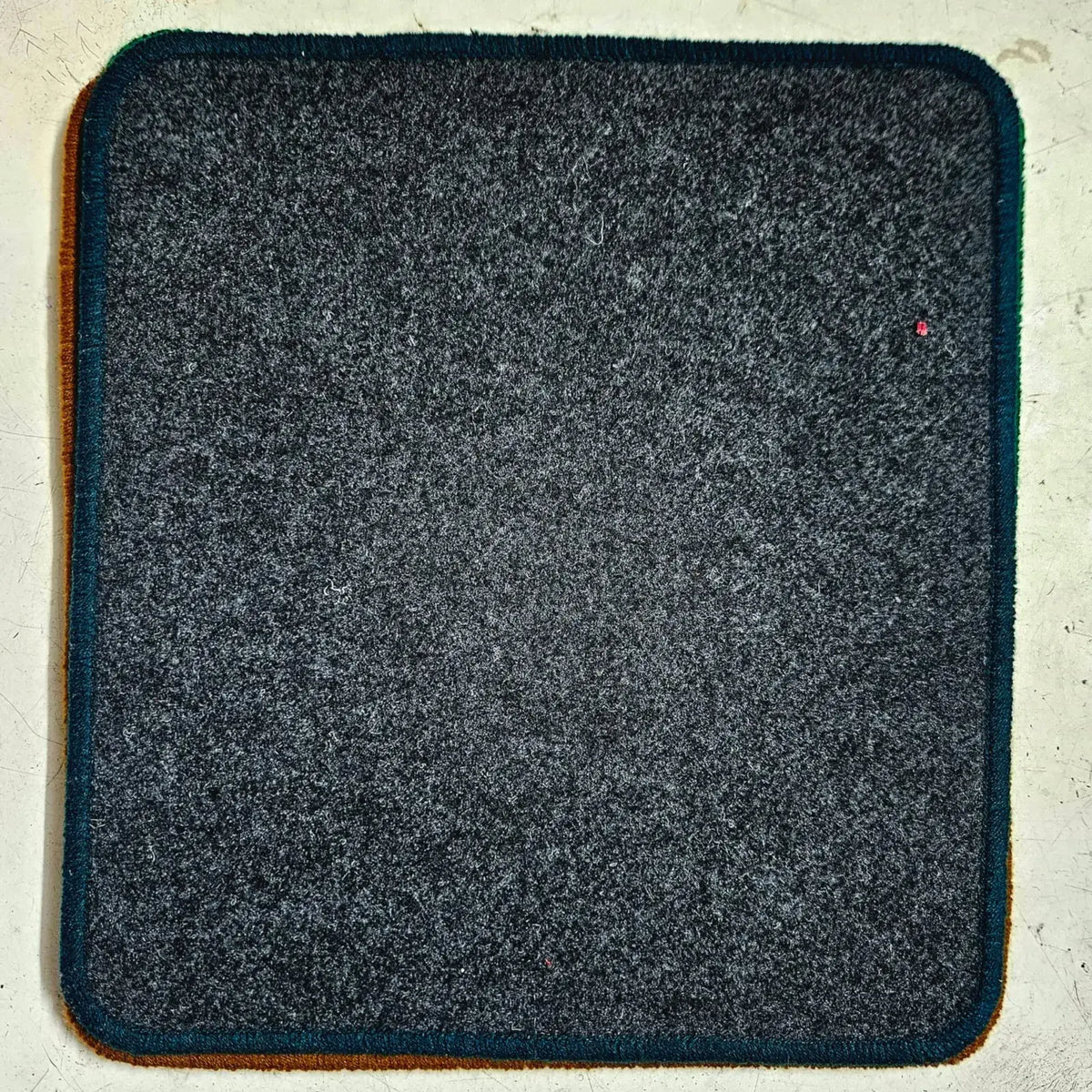 Grey manual typewriter table mat with rounded corners and thick finish for typing machine care and support