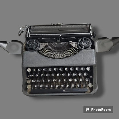 Hermes Baby Rocket typing machine front view with open ribbon covers, showing spools, typebars and round keys