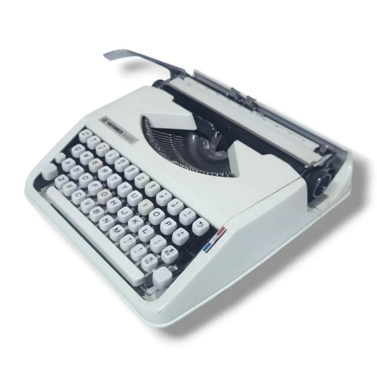 Angled Hermes Baby typing machine in white finish, imported typewriter by trusted Typewriter Seller India