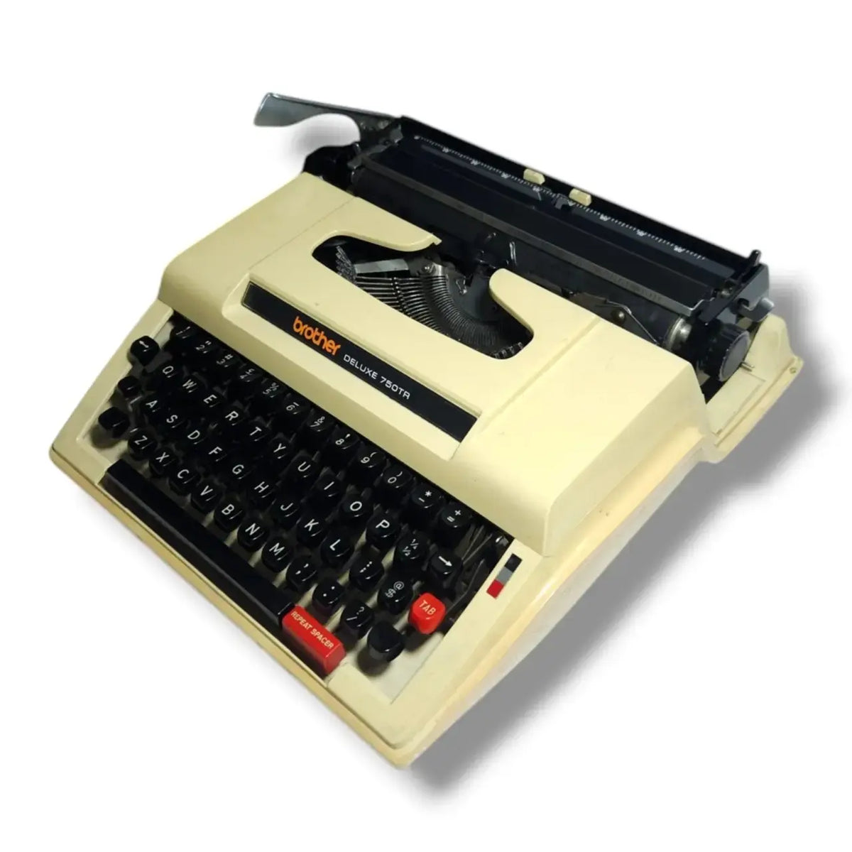 Angled view of Brother typewriter showing compact portable body and smooth manual typing keys