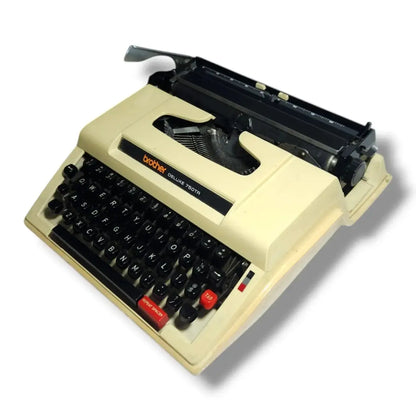Angled view of Brother typewriter showing compact portable body and smooth manual typing keys