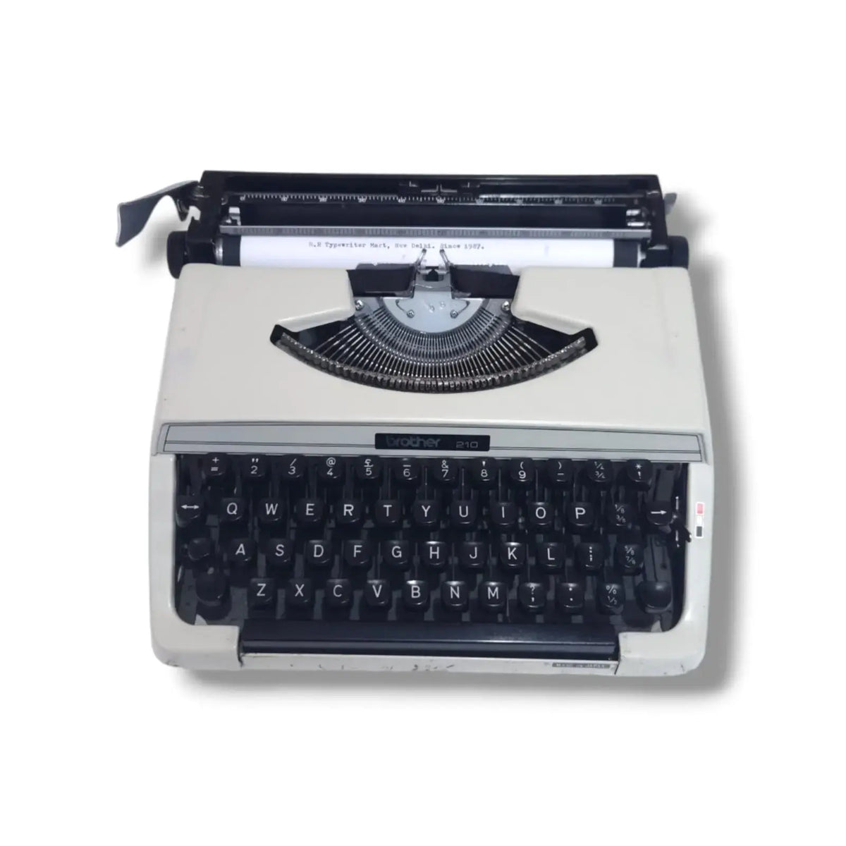 Brother 210 portable English typewriter front view with paper loaded, Japanese manual typing machine ready for daily writing