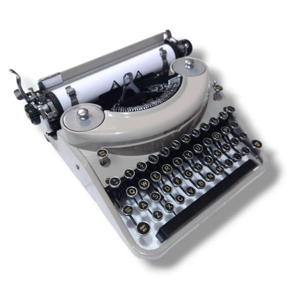 Remington Rand Noiseless typewriter angled view showing cream finish, round keys and vintage manual typing machine build