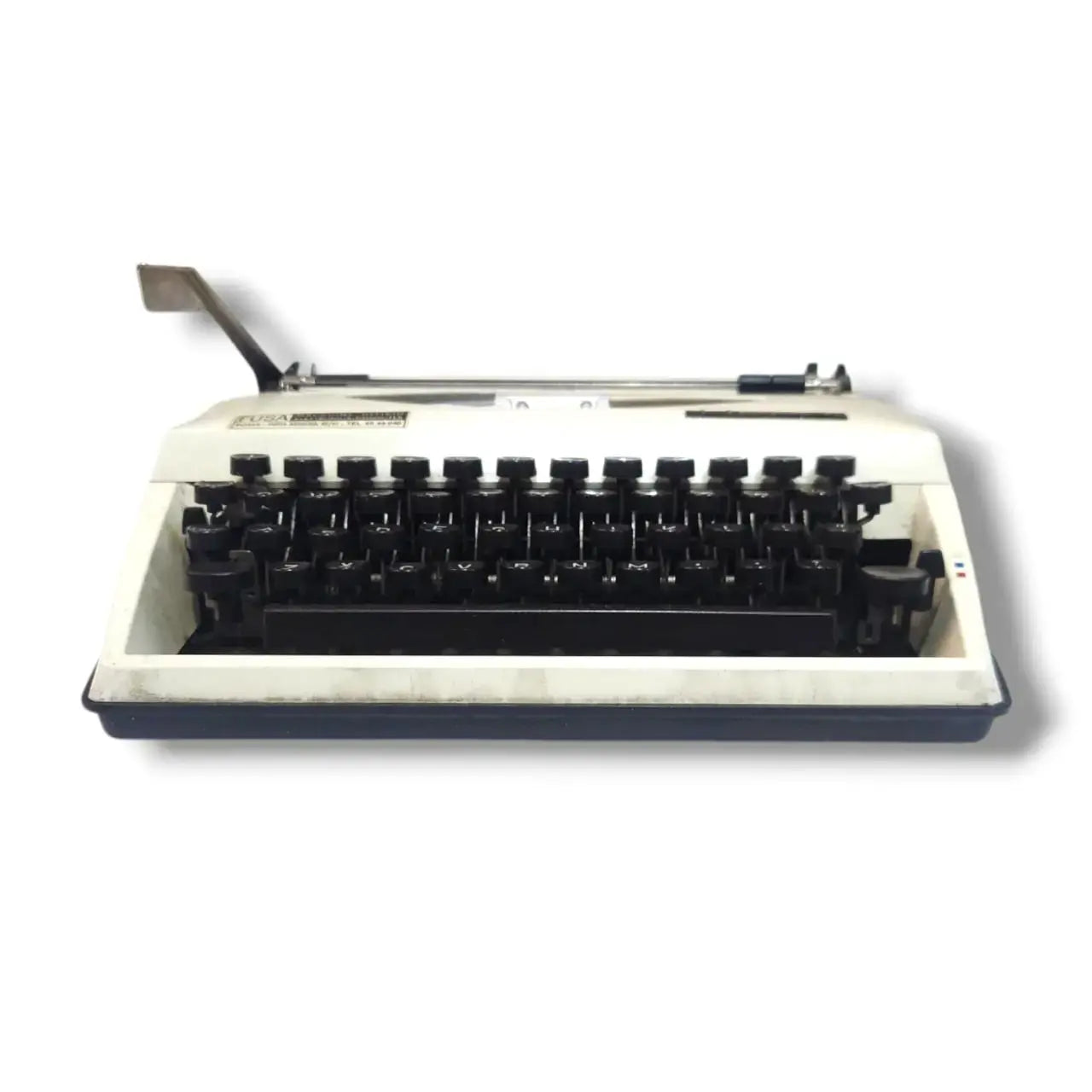 Adler Tippa Triumph manual typewriter low front view showing black English keys, cream body and carriage lever