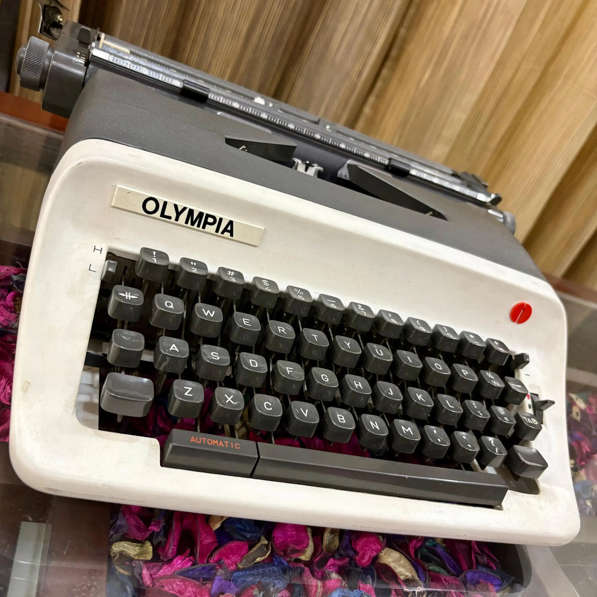 Angled close-up of Olympia manual typewriter keys and logo, English portable typing machine