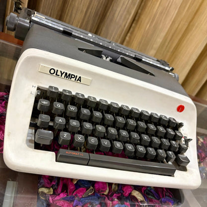 Angled close-up of Olympia manual typewriter keys and logo, English portable typing machine