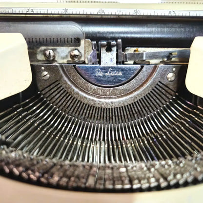 Close-up of Olympia typebars and logo on imported portable typewriter from trusted typewriter shop
