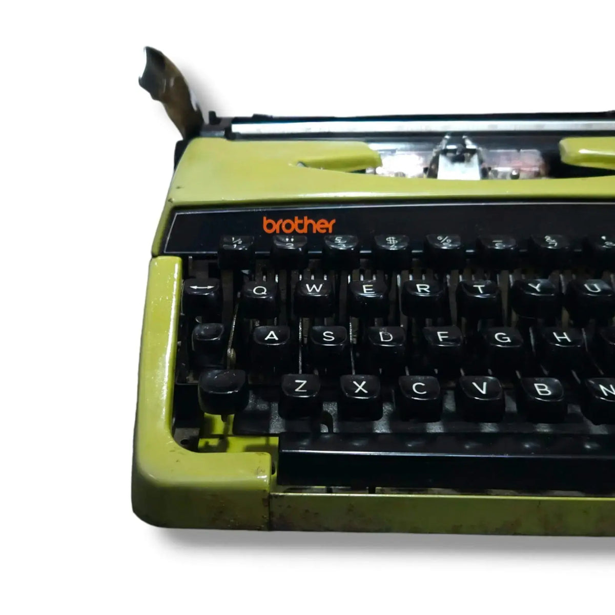 Close-up of Brother Deluxe 220 olive green typewriter keyboard, manual English typing machine for writers and typists