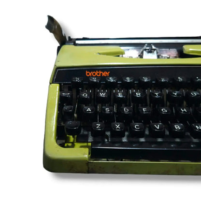Close-up of Brother Deluxe 220 olive green typewriter keyboard, manual English typing machine for writers and typists