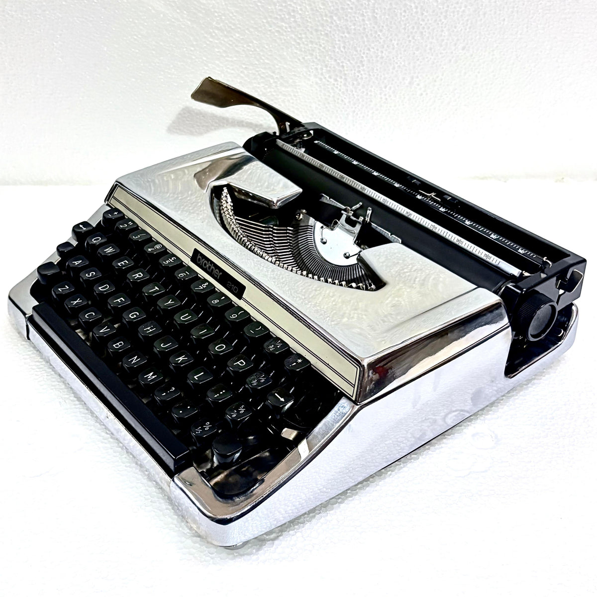 Brother 210 chrome typewriter with black keys, reflective body and restored mechanical typing action in India