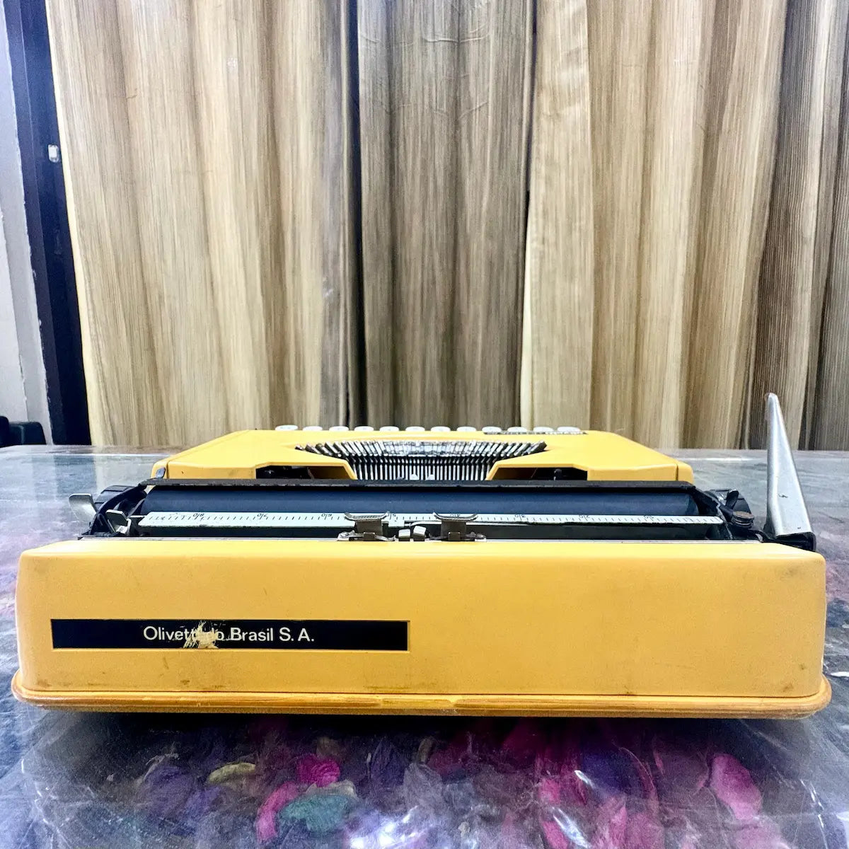 Rear view of yellow Olivetti Lettera 82 Brazilian portable manual typewriter, showing the Olivetti do Brasil S.A. maker plate, RR Typewriter Mart