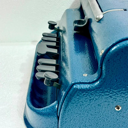 Close-up of blue Perkins Braille Typewriter keys and textured body, a braille typing machine from RR Typewriter Mart.