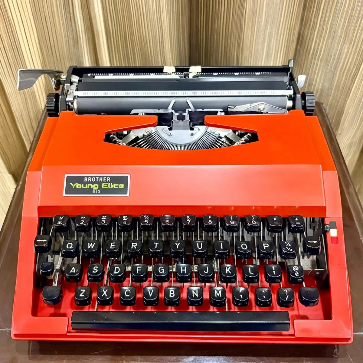Scarlet red Brother Young Elite 513 portable typewriter angled front view, vintage English keyboard and mechanical writing machine | RR Typewriter Mart