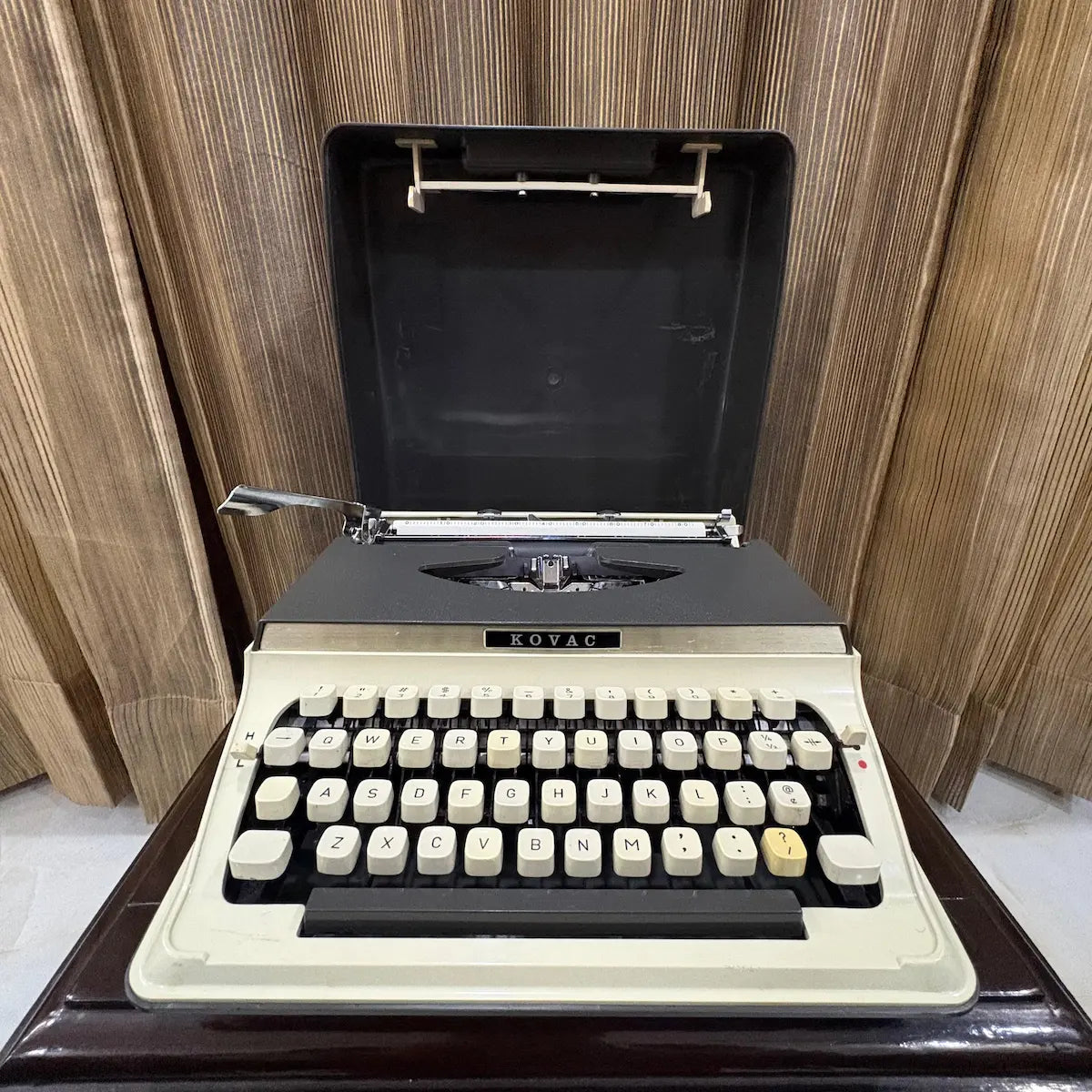 Kovac portable typewriter with factory original grey and white finish, ideal for collectors seeking an untouched vintage machine | RR Typewriter Mart