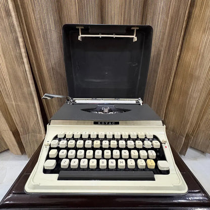 Kovac portable typewriter with factory original grey and white finish, ideal for collectors seeking an untouched vintage machine | RR Typewriter Mart
