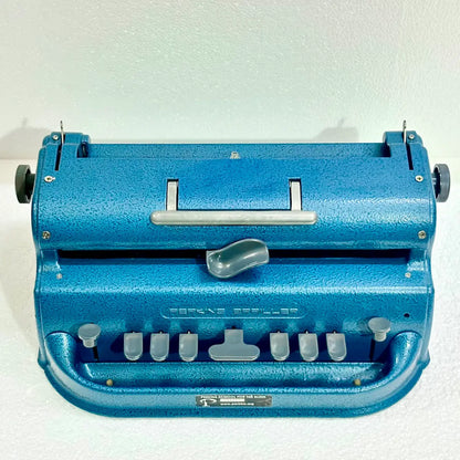 Blue Perkins Braille Typewriter front view showing six-key layout, original finish and sturdy body, from RR Typewriter Mart