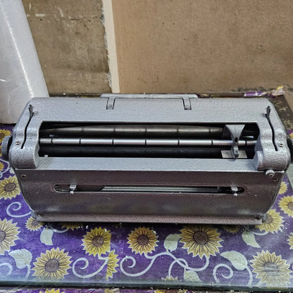Rear view of Perkins Braille Typewriter showing paper feed assembly, braille typing machine for schools and users