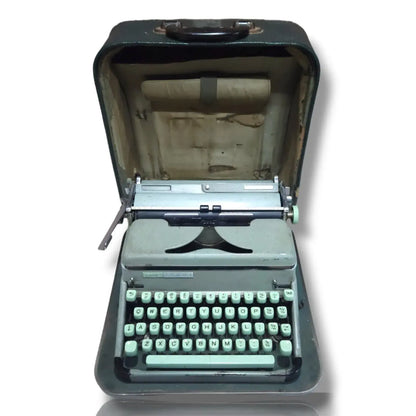 Vintage green typewriter on a white background