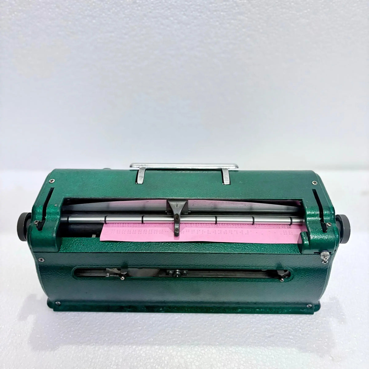 Rear view of Perkins Braille Typewriter with embossed paper, manual Braille typing machine design