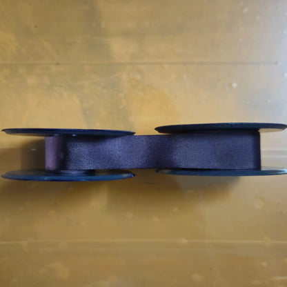 Side view of purple manual typewriter ribbons on spools, buy typewriter ribbon roll for typing machines