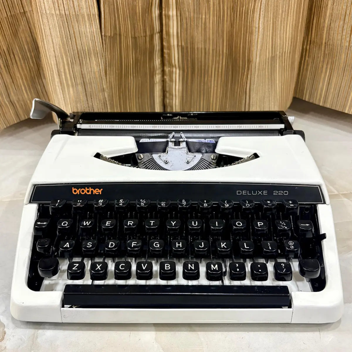 Pearl White Brother Deluxe 220 typewriter with black keyboard, classic carriage and compact body, restored for collectors in India