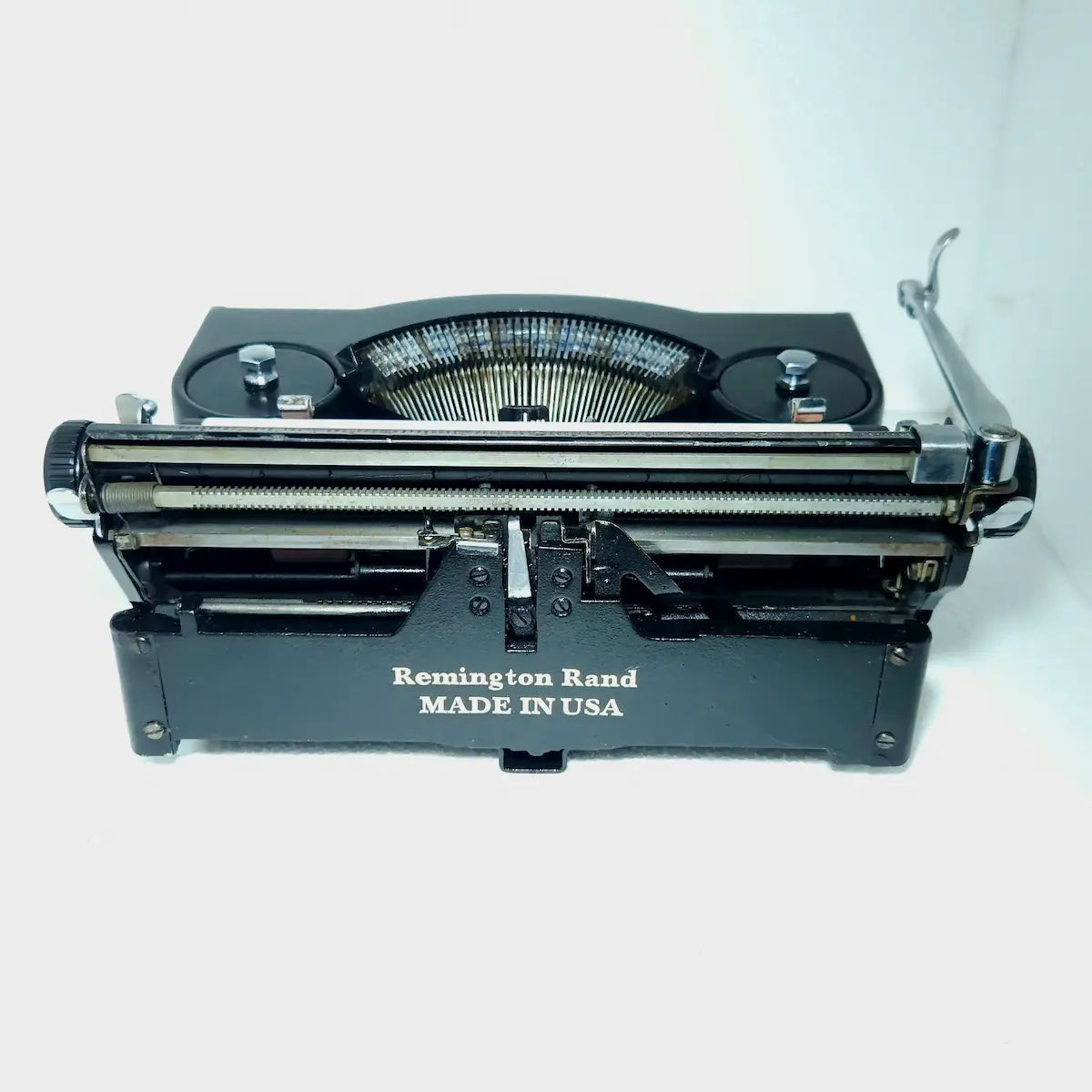 Rear view of Remington Noiseless Model 1 typewriter showing carriage and Made in USA mark on restored black body