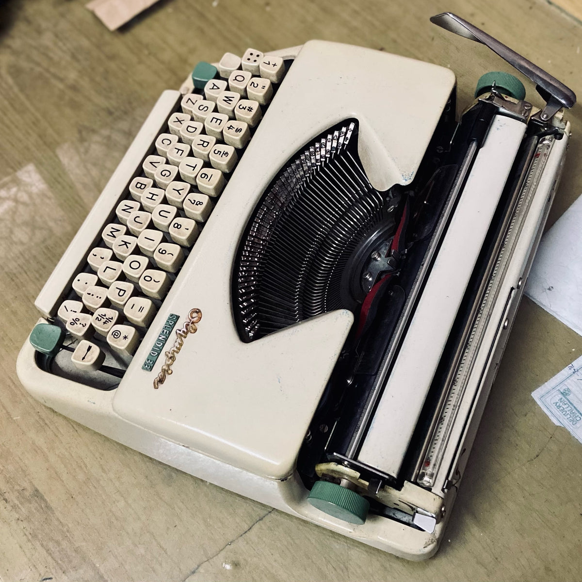 Olympia Splendid 33 vintage portable typewriter, top view showing typebars, carriage and manual keyboard