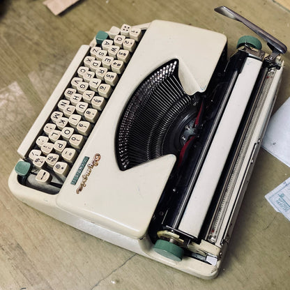 Olympia Splendid 33 vintage portable typewriter, top view showing typebars, carriage and manual keyboard