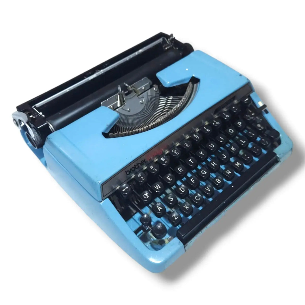 Angled view of blue Brother Charger 11 Correction typewriter, vintage manual typing machine for writers and collectors